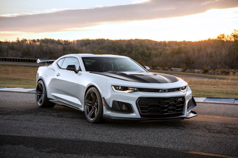 2018 Chevrolet Camaro ZL1 1LE front end angle from passenger side parked on a race track with the sun setting in the back.