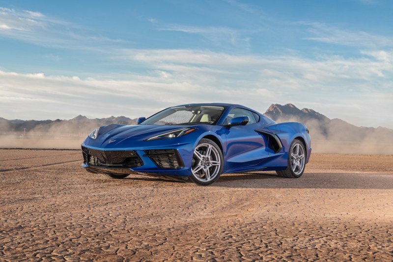 2020 Chevrolet Corvette Stingray front end angle from driver's side in the desert in front of mountains.
