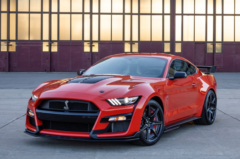2022 Ford Mustang Shelby GT500 front end angle from driver's side in front of a warehouse.