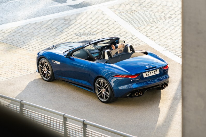 2022 Jaguar F-Type rear end overhead shot in front of a building with the top down.