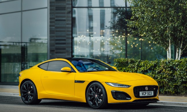 2022 Jaguar F-Type front end angle from passenger's side parked on the side of a street with a glass building in the background.