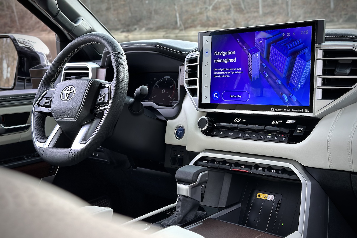 Close up of dashboard and steering wheel in 2022 Toyota Tundra Hybrid Capstone from the rear seats.