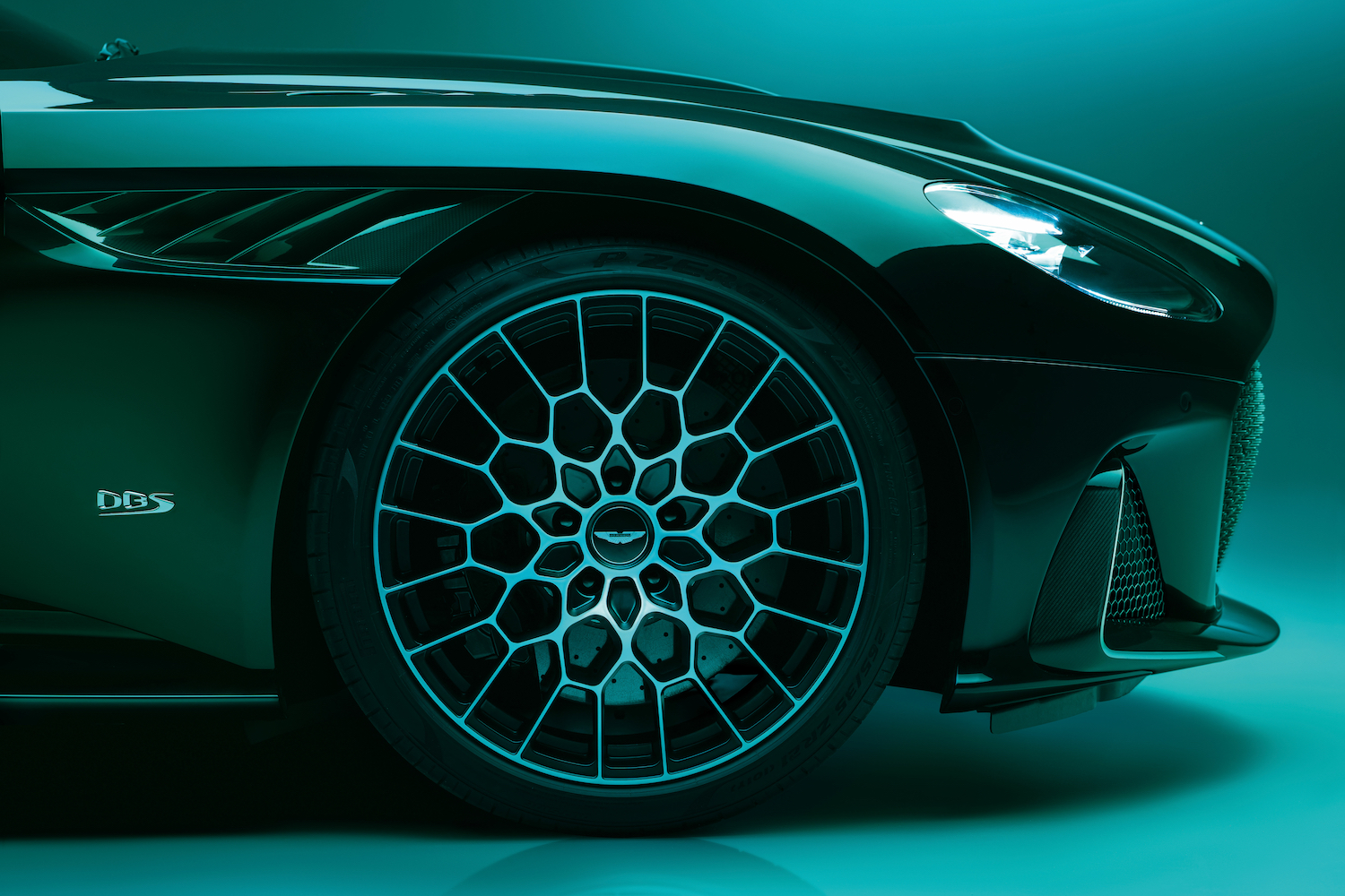 Side profile of front end of 2023 Aston Martin DBS 770 Ultimate with a focus on the front right wheel.
