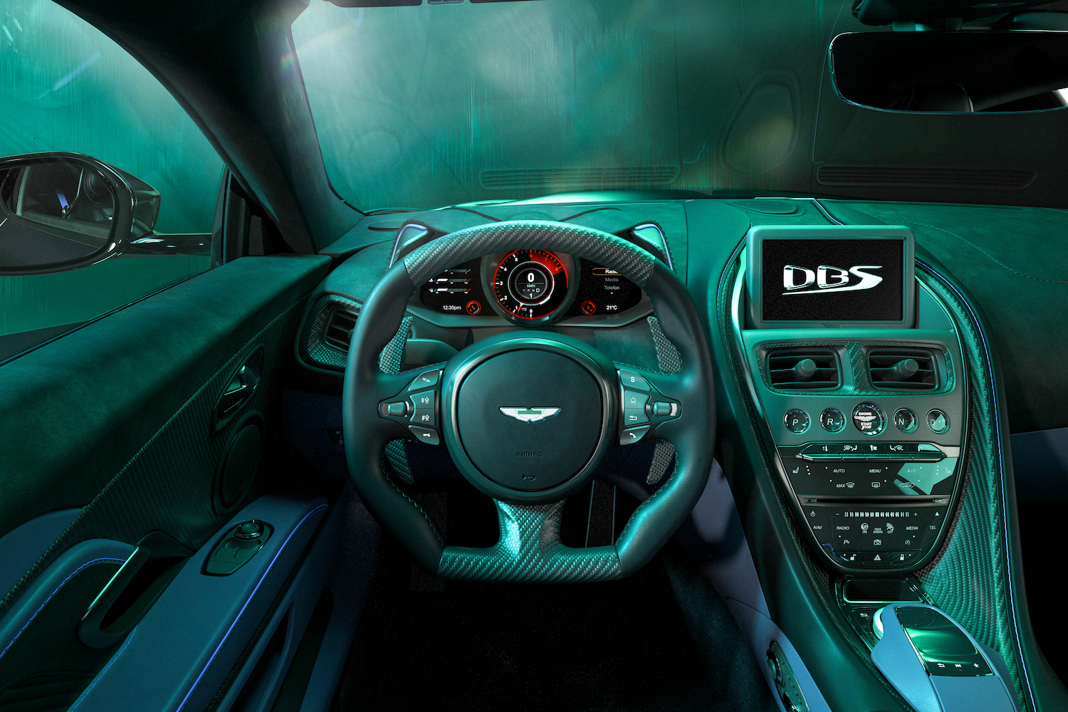 Close up of steering wheel and dashboard in the 2023 Aston Martin DBS 770 Ultimate in a green studio with dramatic lighting.