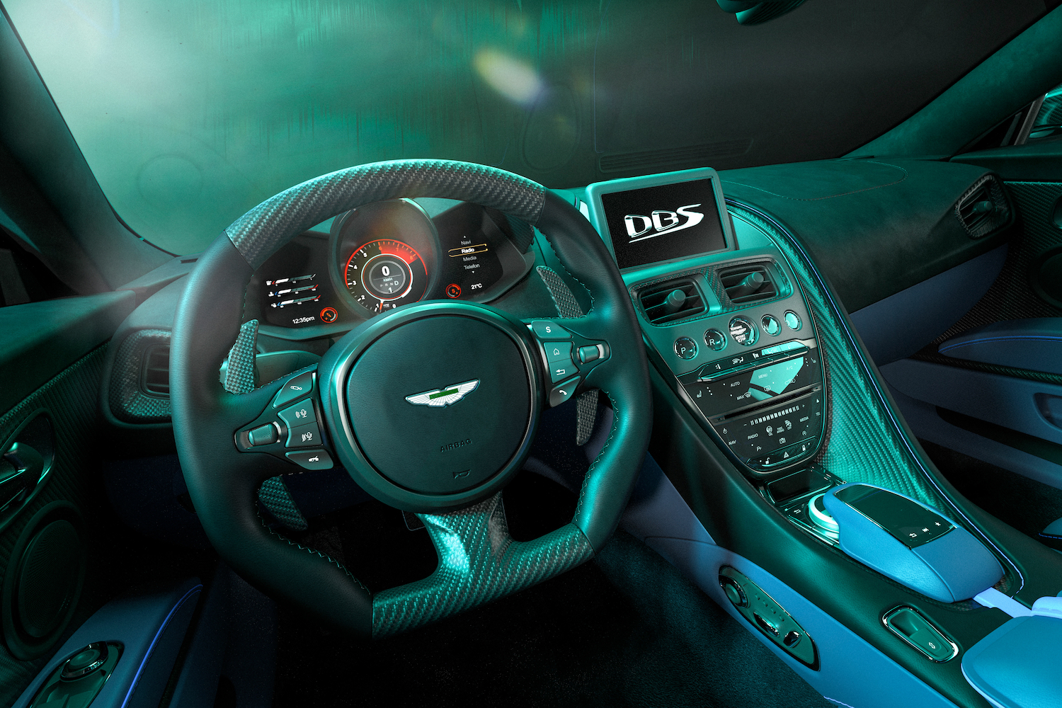 2023 Aston Martin DBS 770 Ultimate close up of steering wheel and dashboard from driver's seat in a green studio.