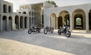 2023 BMW R 18 and R nineT 100 Years Editions in front of a villa during sunset and parked on a dirt parking lot.