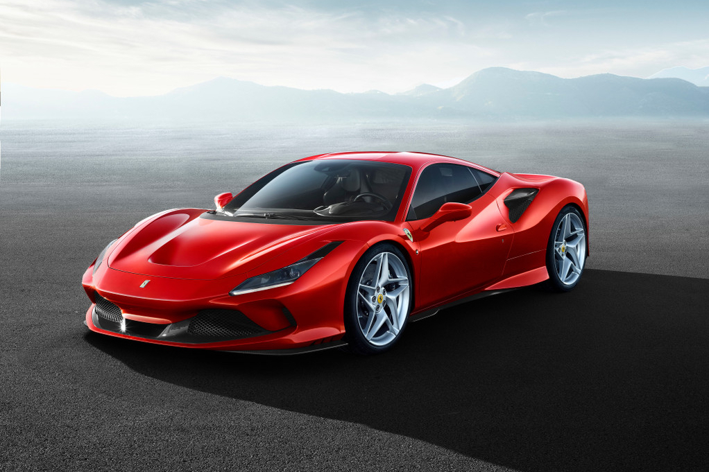 Front end angle of 2023 Ferrari F8 Tributo parked in front of mountains in the distance.