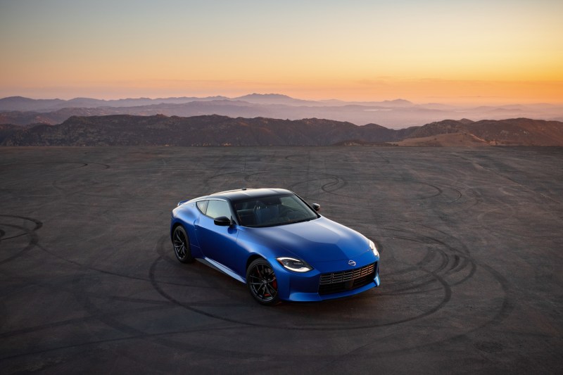 2023 Nissan Z overhead shot of front end angle in front of a sunset with mountains in the back.
