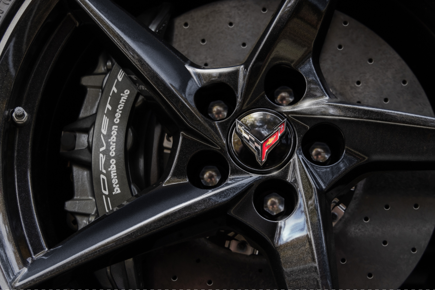 Close up of carbon ceramic brakes in the 2024 Chevrolet Corvette E-Ray with carbon fiber wheels.