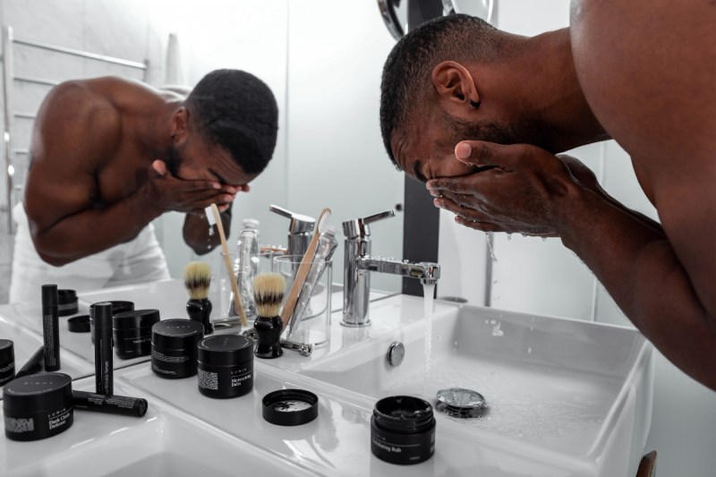 Man washing his face in the bathroom.