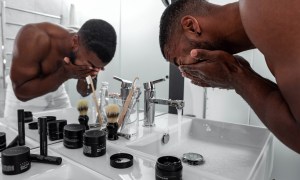 Man washing his face in the bathroom.