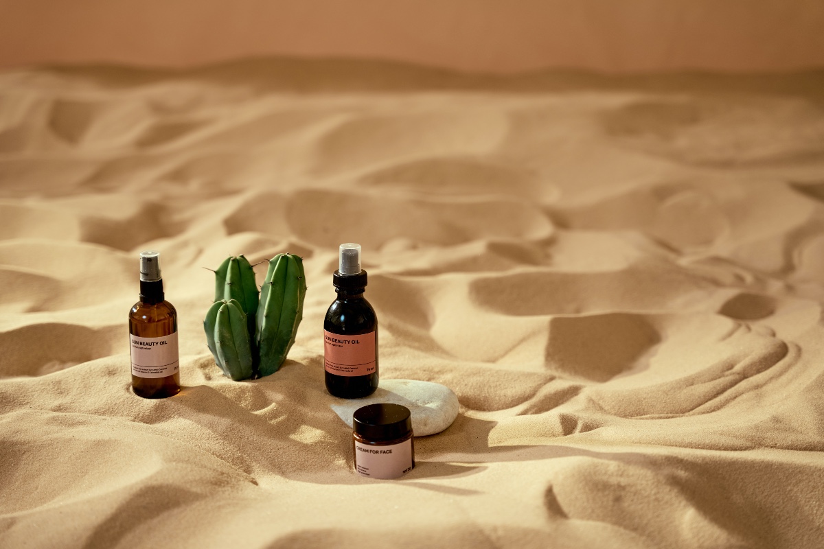 skincare products in the sand
