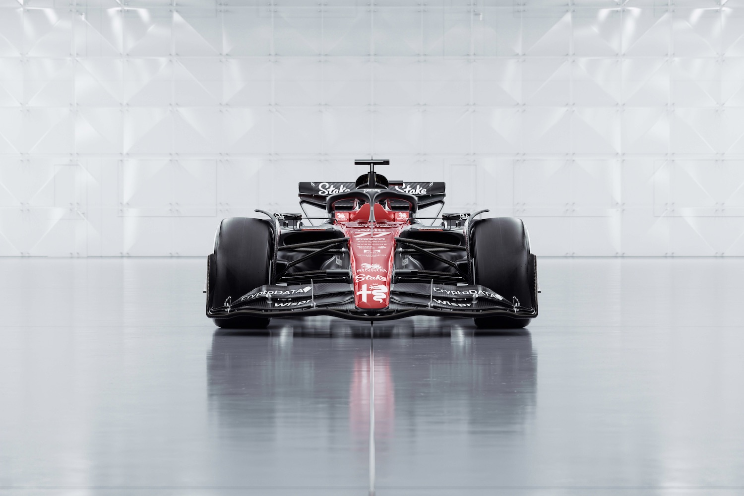 Front end close up of the 2023 Alfa Romeo F1 C43 show car parked in a studio with bright studio lighting.