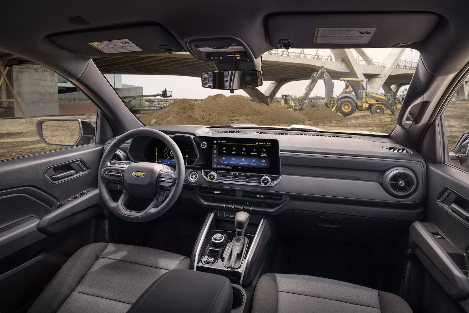 2023 Chevrolet Colorado Interior of the WT trim at a job site with dirt in the back.