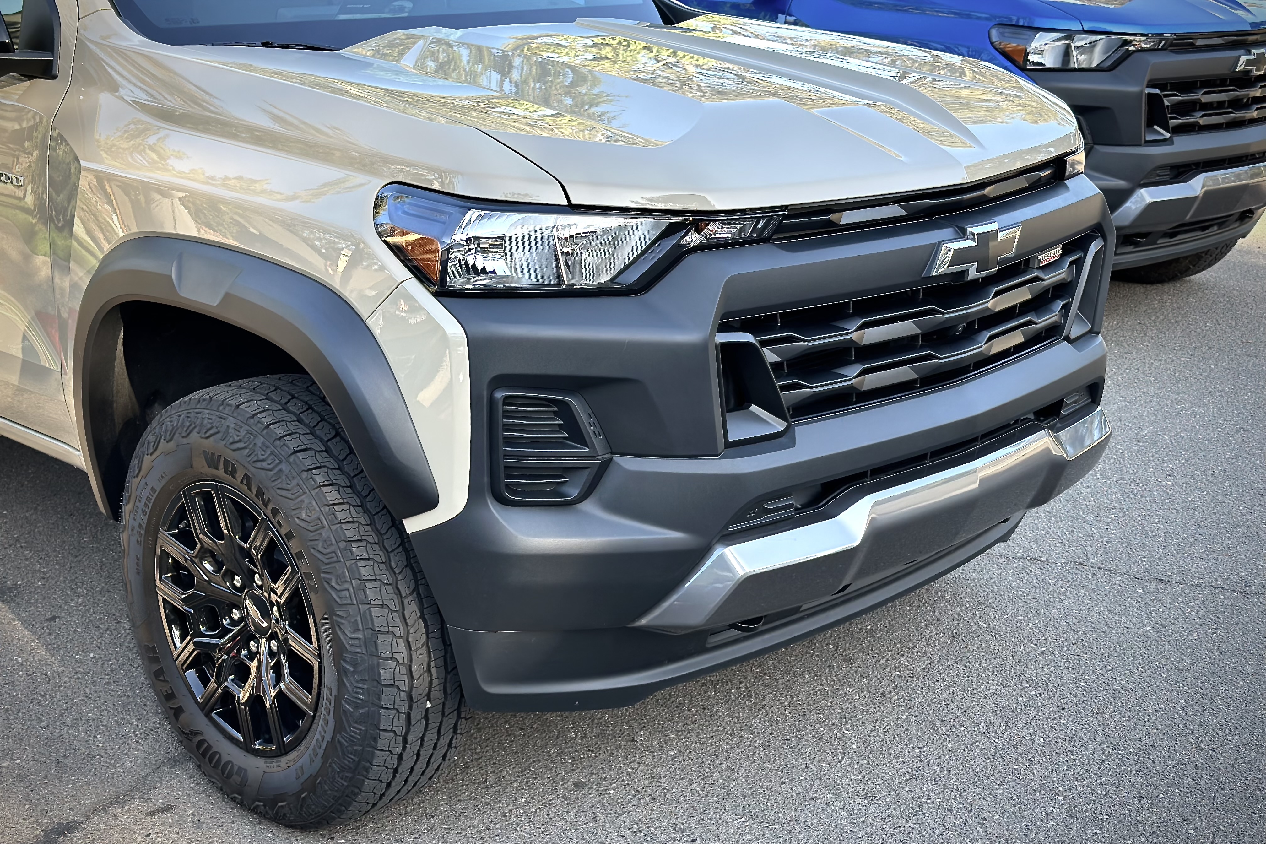 Close up of the front end on the 2023 Chevrolet Colorado Trail Boss parked in a parking lot.