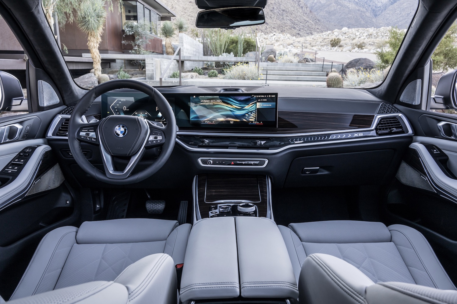 Close up of front dashboard and steering wheel in the 2024 BMW X5 and X6 from the rear seats.