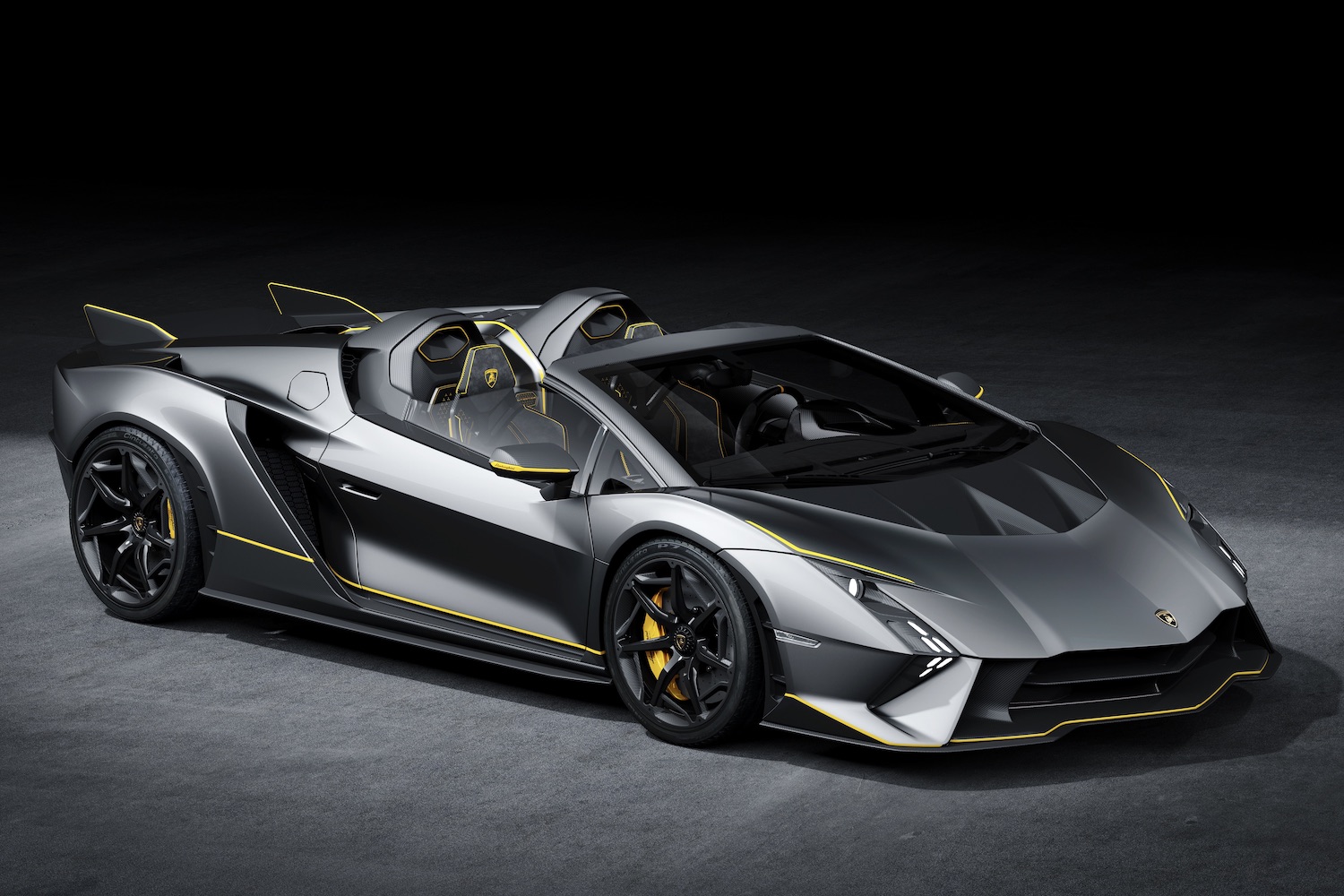 Front end angle of Lamborghini Auténtica from passenger side in a dark studio with studio lighting.