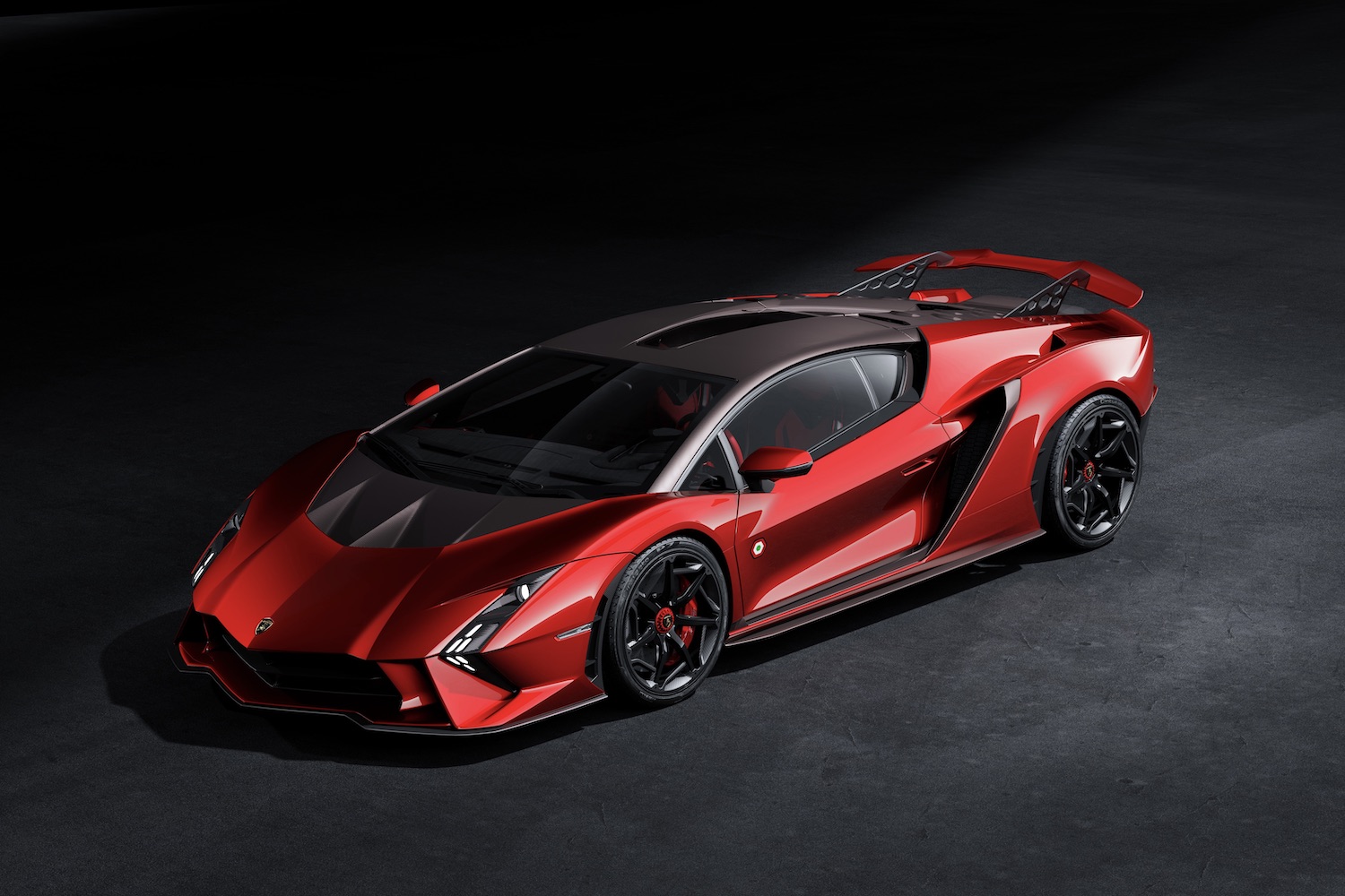 Front end angle of Lamborghini Invencible from driver's side in a dark studio with studio lighting.