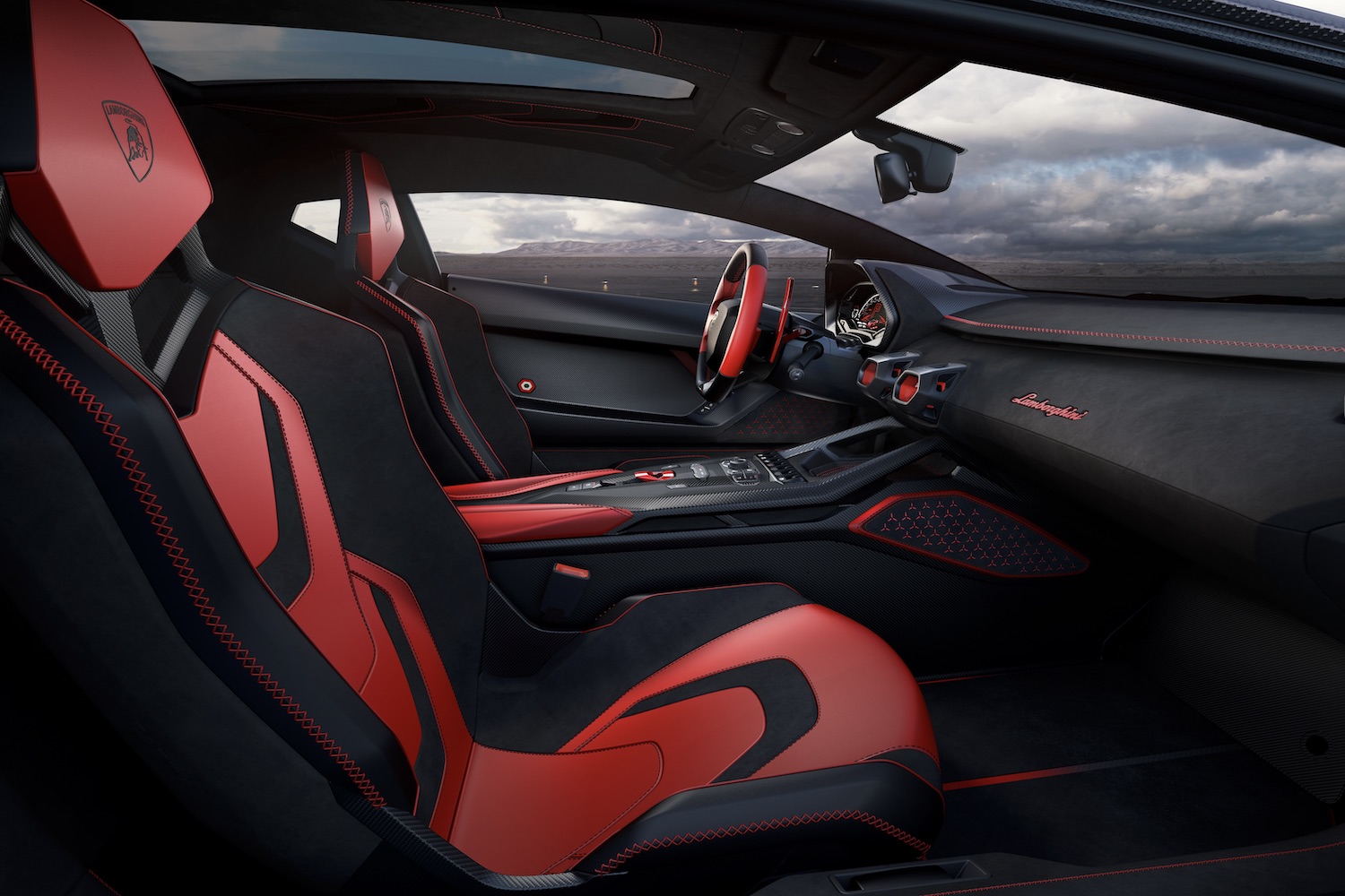 Front seats in the Lamborghini Invencible with dark clouds in the back.