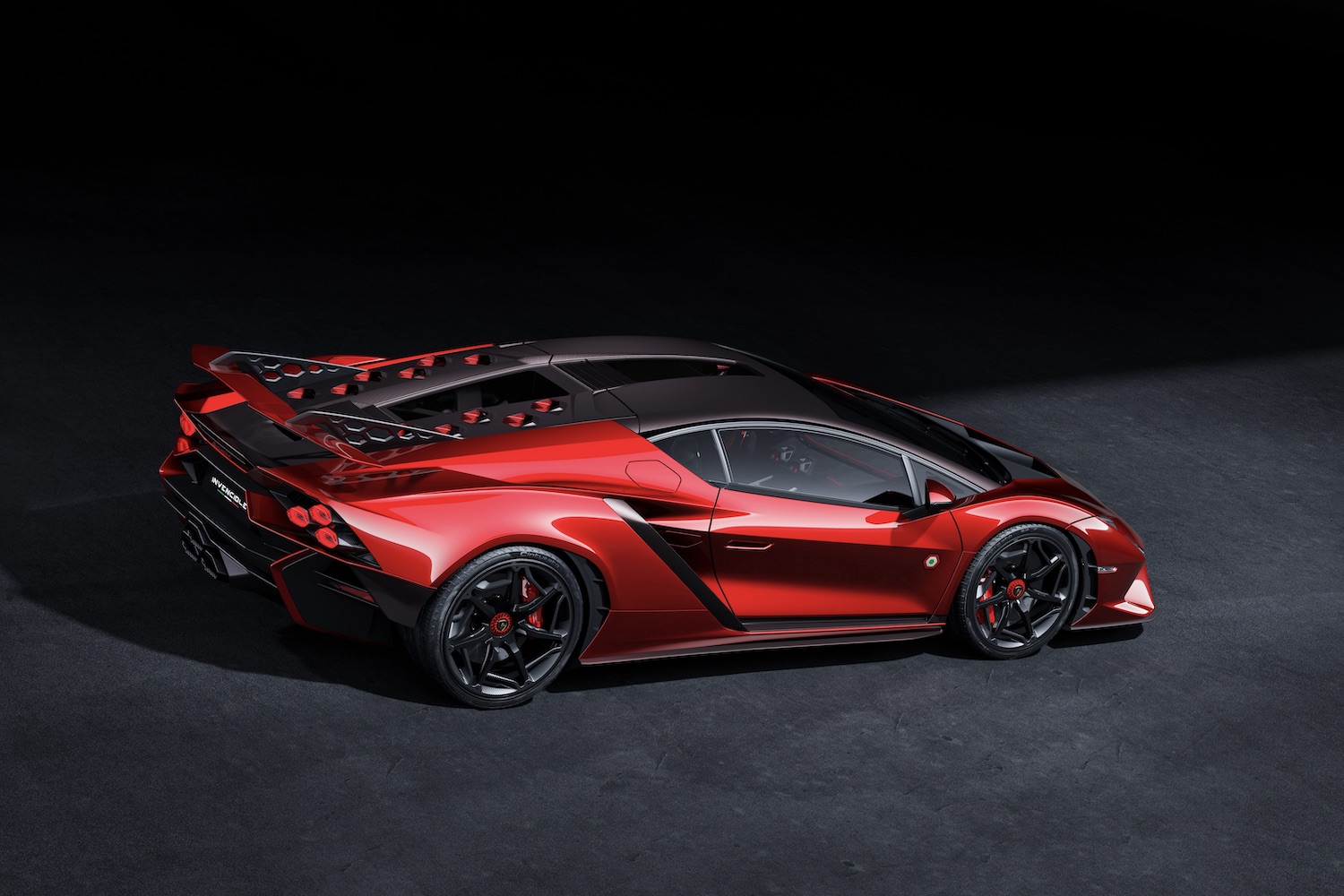 Side profile of Lamborghini Invencible in a dark studio with studio lighting.