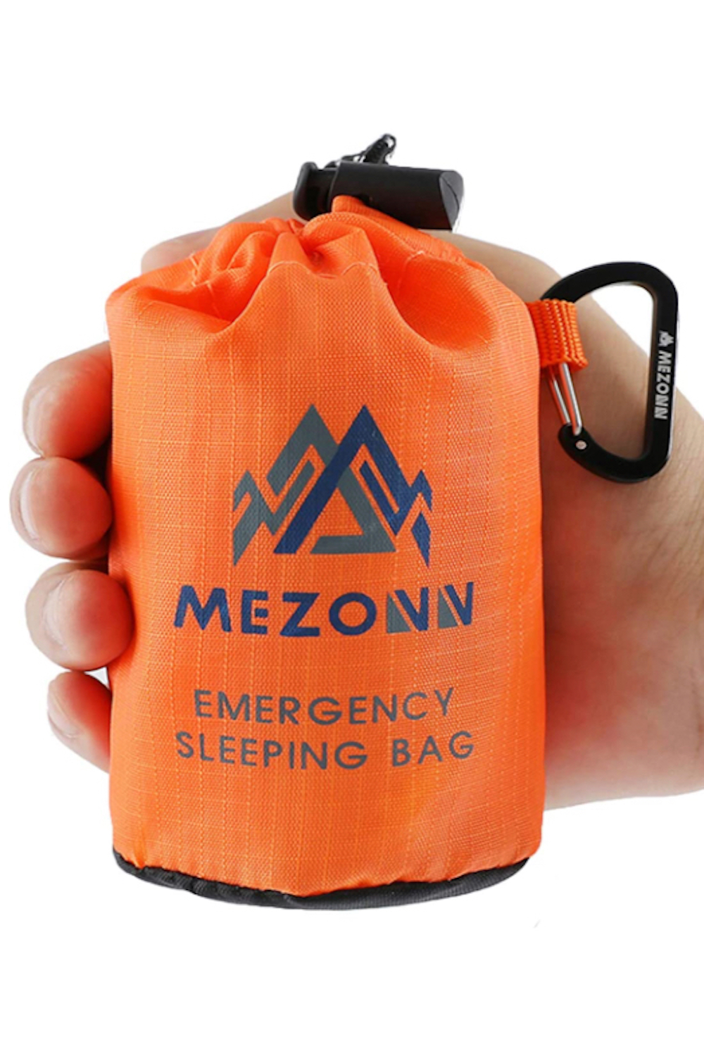 A man holding a Mezonn Emergency Sleeping Bag that's packed away in front of a white screen.