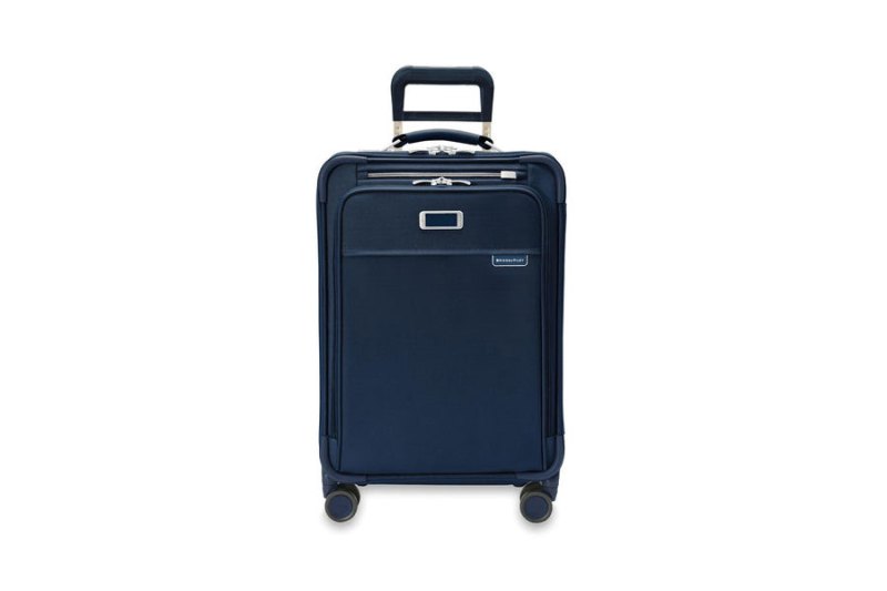 Briggs & Riley Baseline Essential Carry-On Expandable Spinner (in navy) on a white studio background.