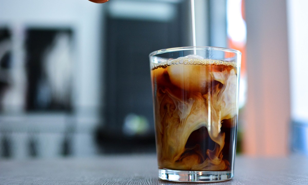 Pouring cream in cold brew coffee