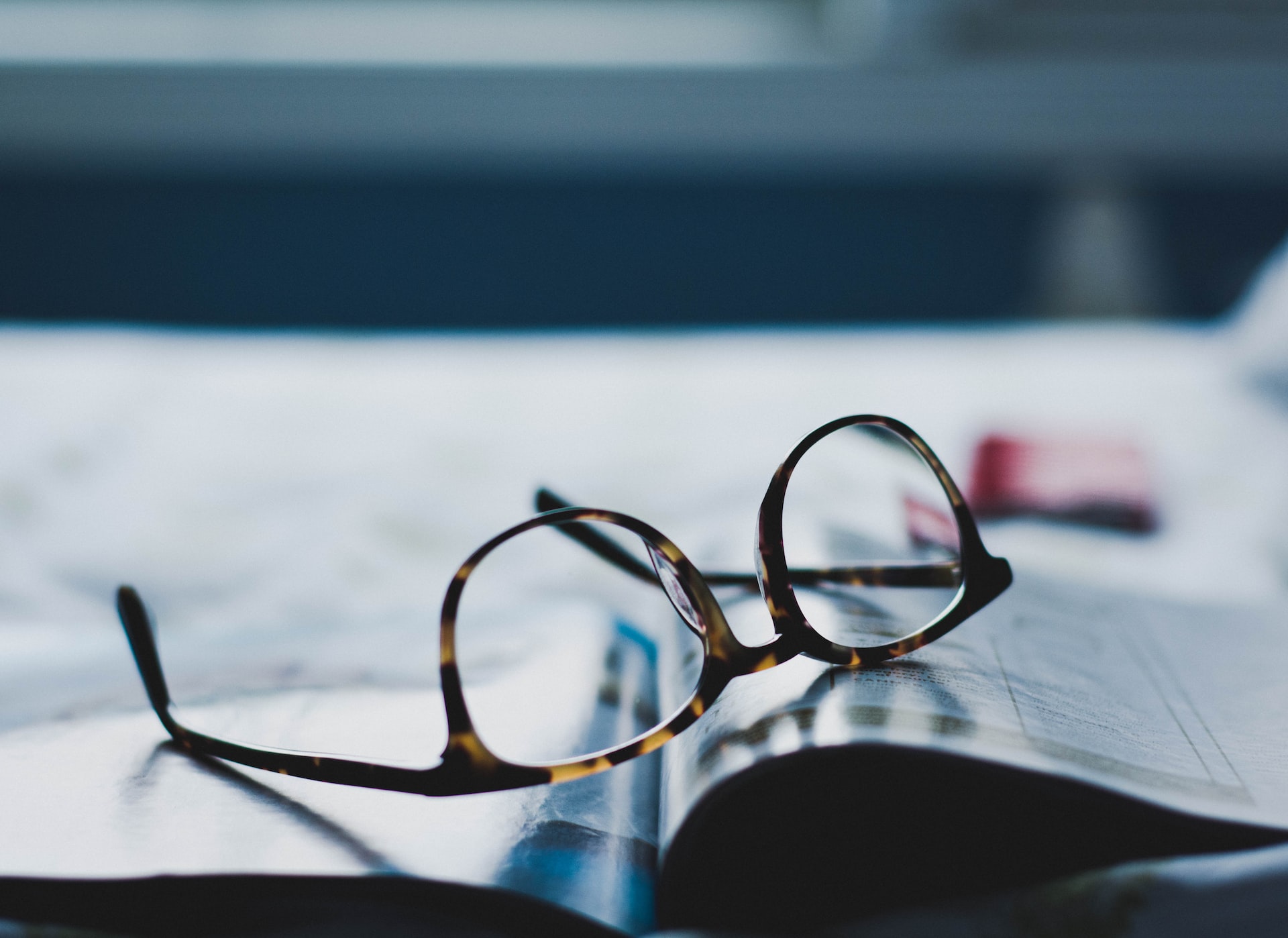 Glasses set on a book upside down.