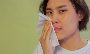 man wiping his face