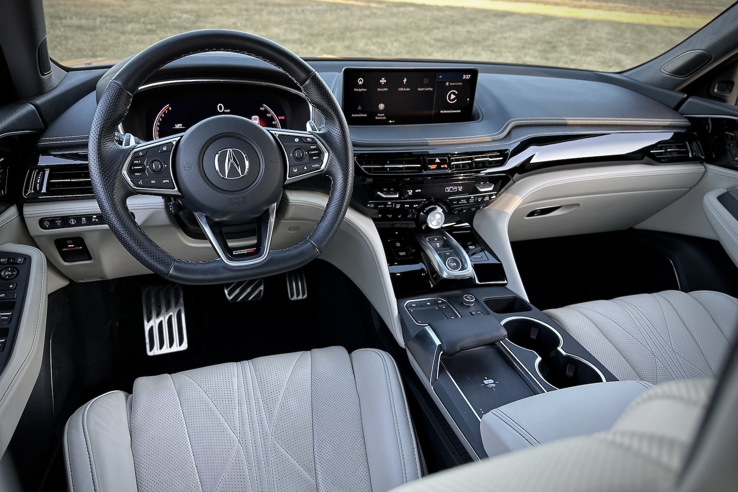 2022 Acura MDX Type S close up of steering wheel in the 2022 Acura MDX Type S with grass in the back.