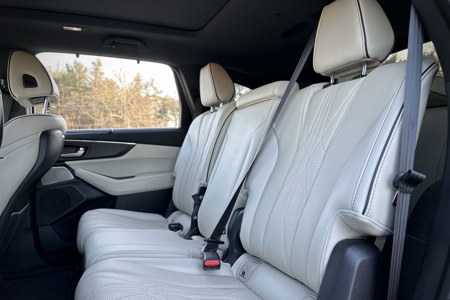 Rear seats in the 2022 Acura MDX Type S from outside the vehicle with trees in the back.
