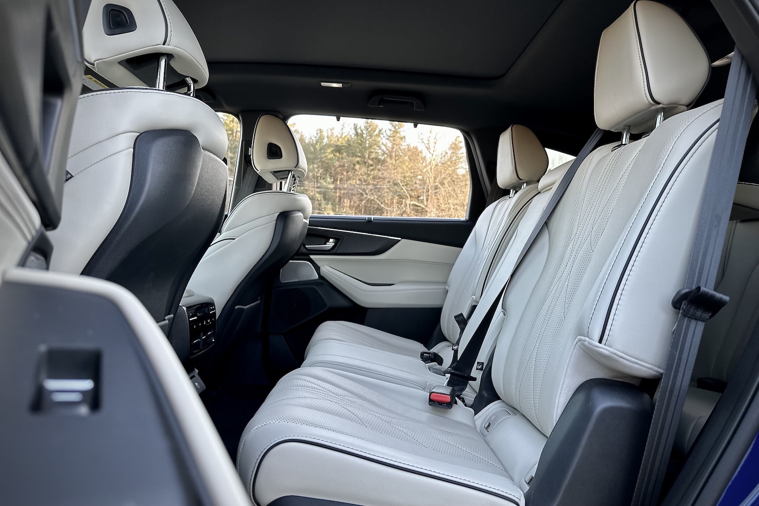 Second-row seats in the 2022 Acura MDX Type S from outside the vehicle with trees in the back.