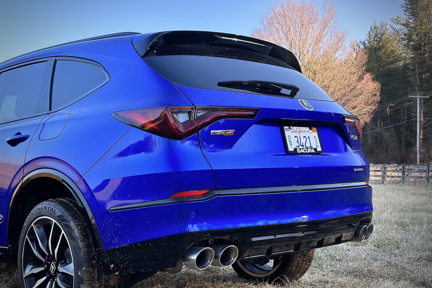 Close up of rear end on the 2022 Acura MDX Type S with trees in the back.