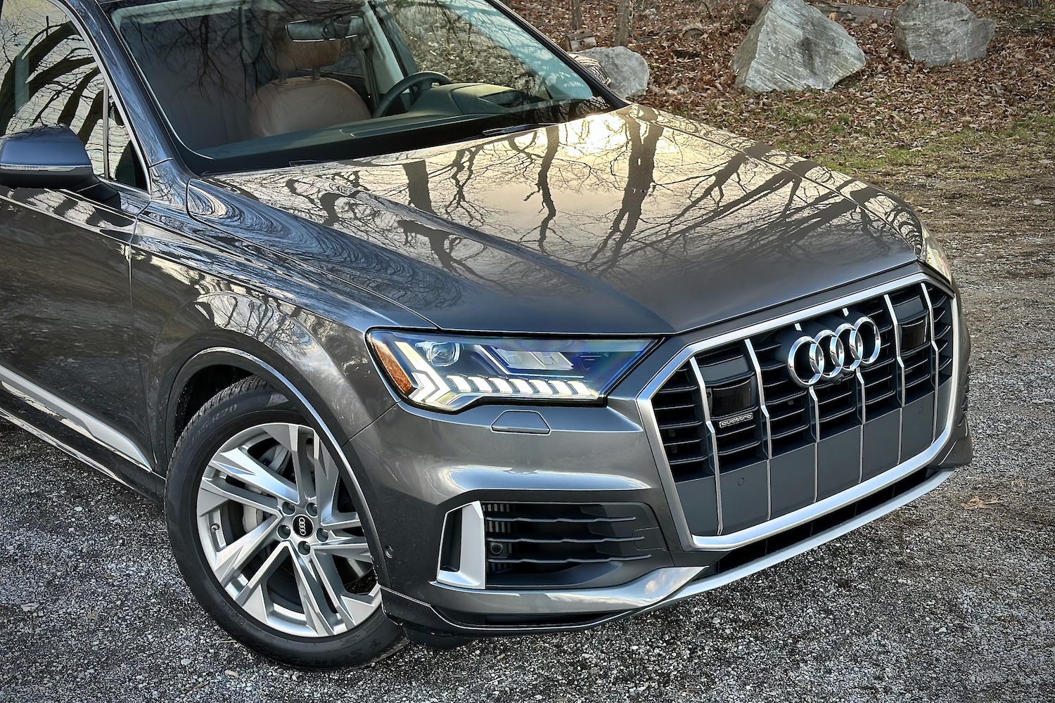 Front end overhead photo of the 2022 Audi Q7 Prestige parked on a gravel lot.