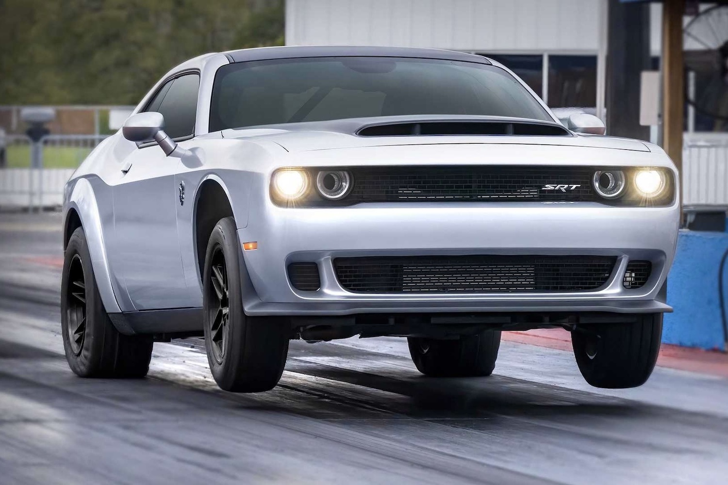 2023 Dodge Challenger SRT Demon 170 pulling a wheelie on a drag strip.