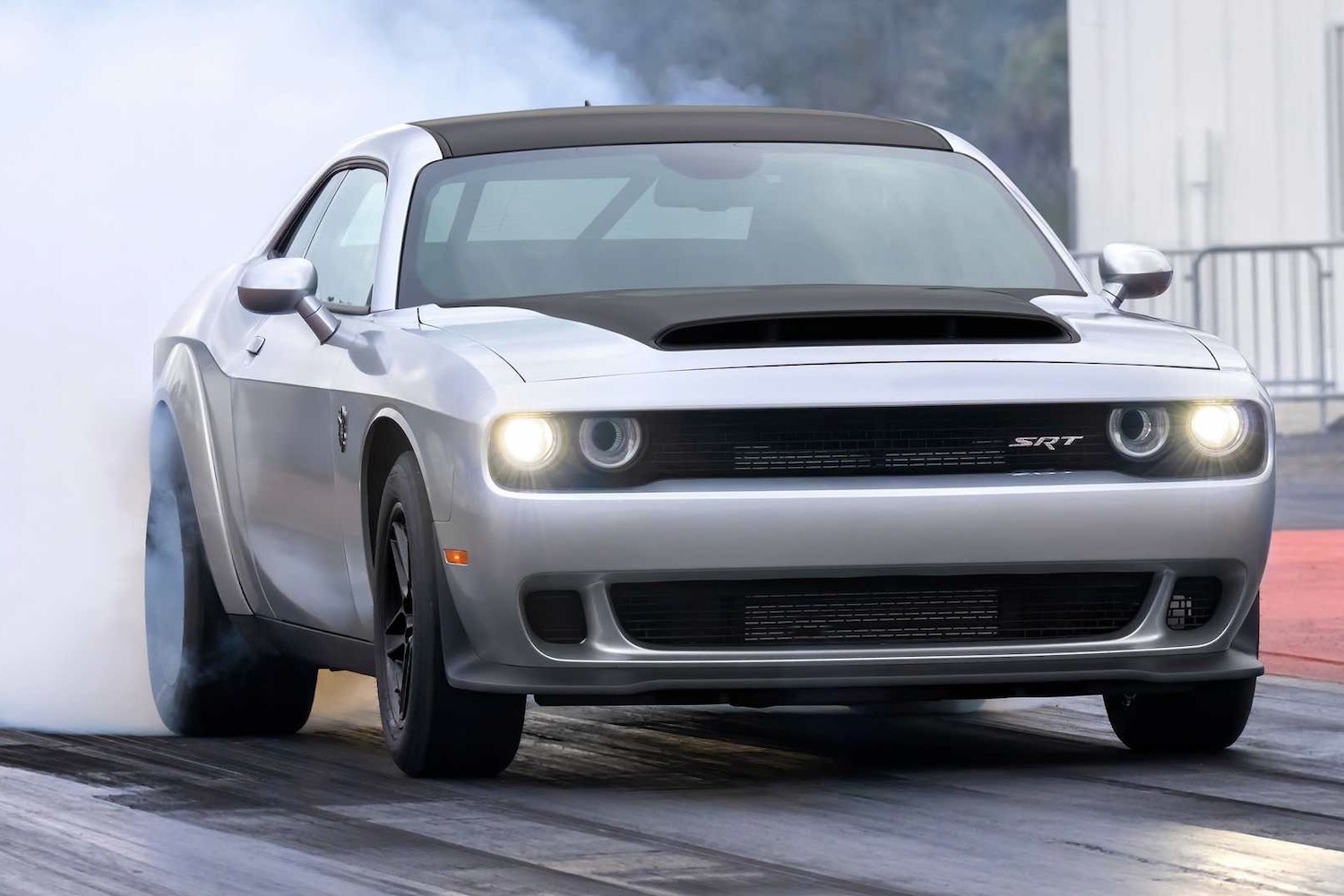 2023 Dodge Challenger SRT Demon 170 front end angle pulling a burnout on a drag strip.