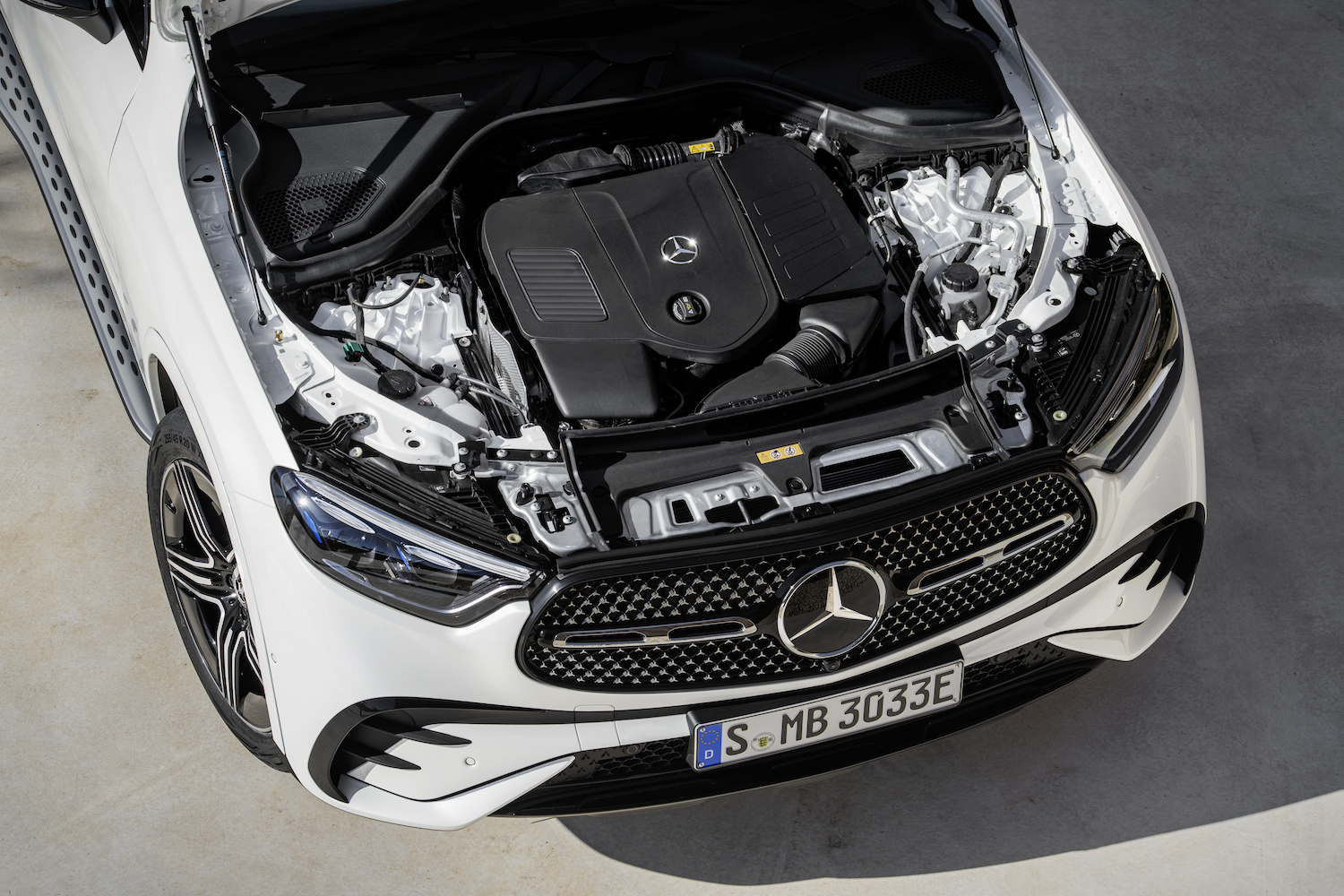 Overhead shot of the engine in the 2023 Mercedes-Benz GLC parked on a road.