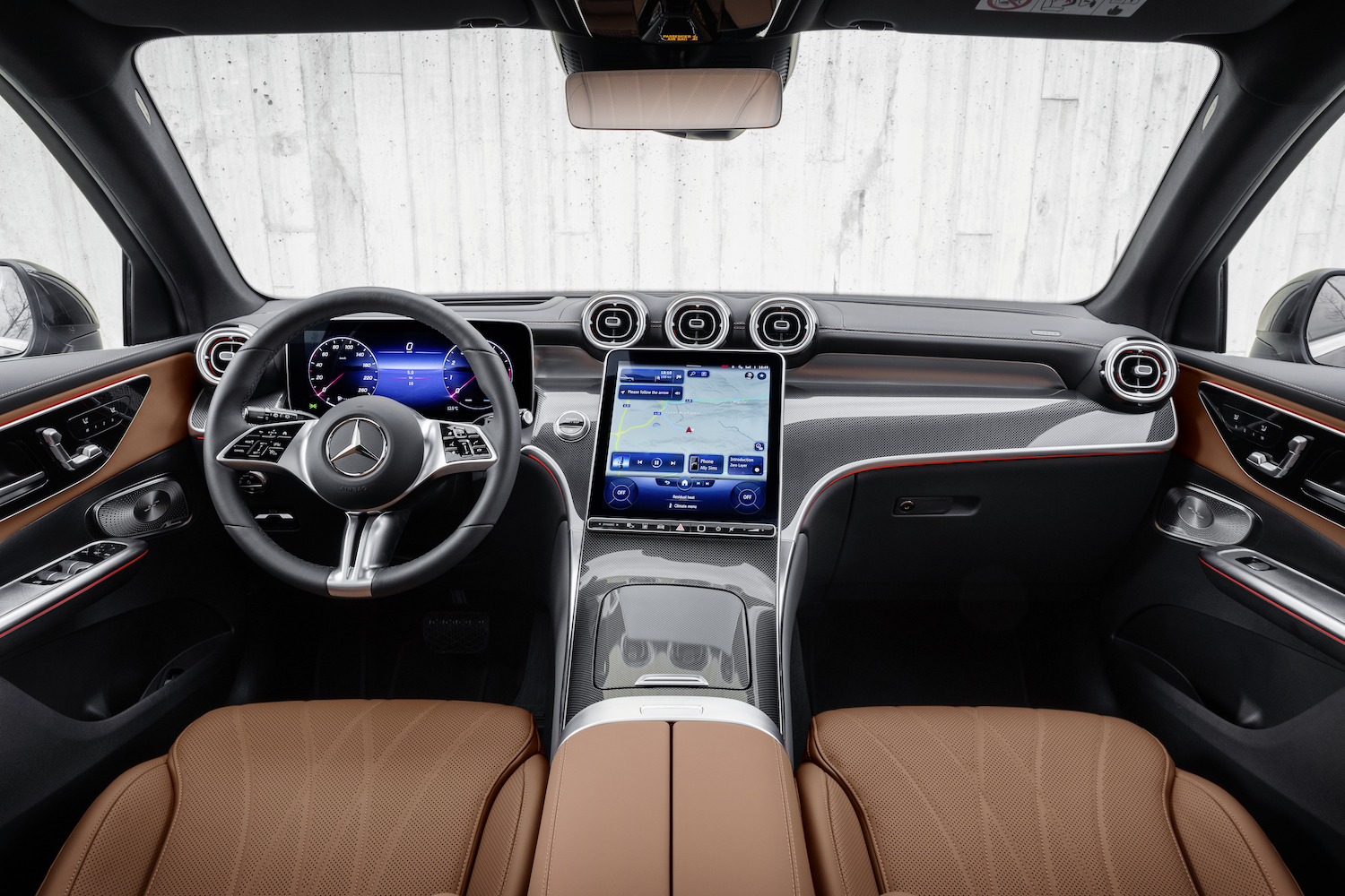 2023 Mercedes-Benz GLC close up of dashboard and steering wheel in front of a white wall.