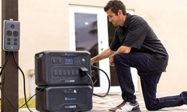 A man using the Bluetti AC300 power station.