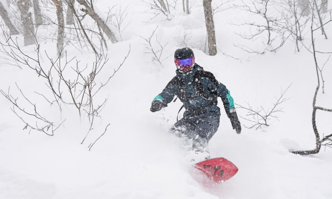 A person snowboarding down a hillside.