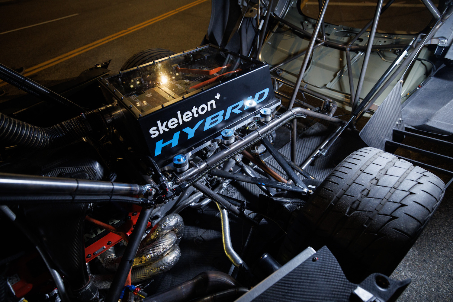 Close up of engine bay in the Honda CR-V Hybrid Racer parked in the middle of the street.