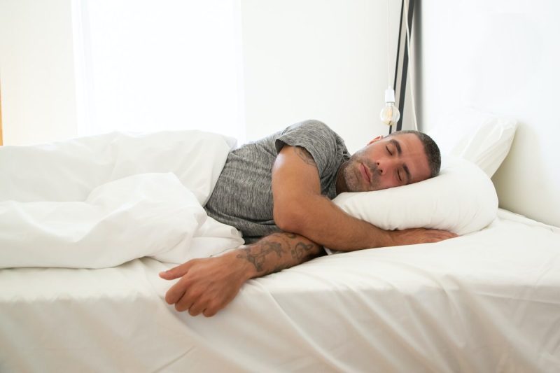 A man asleep in bed.