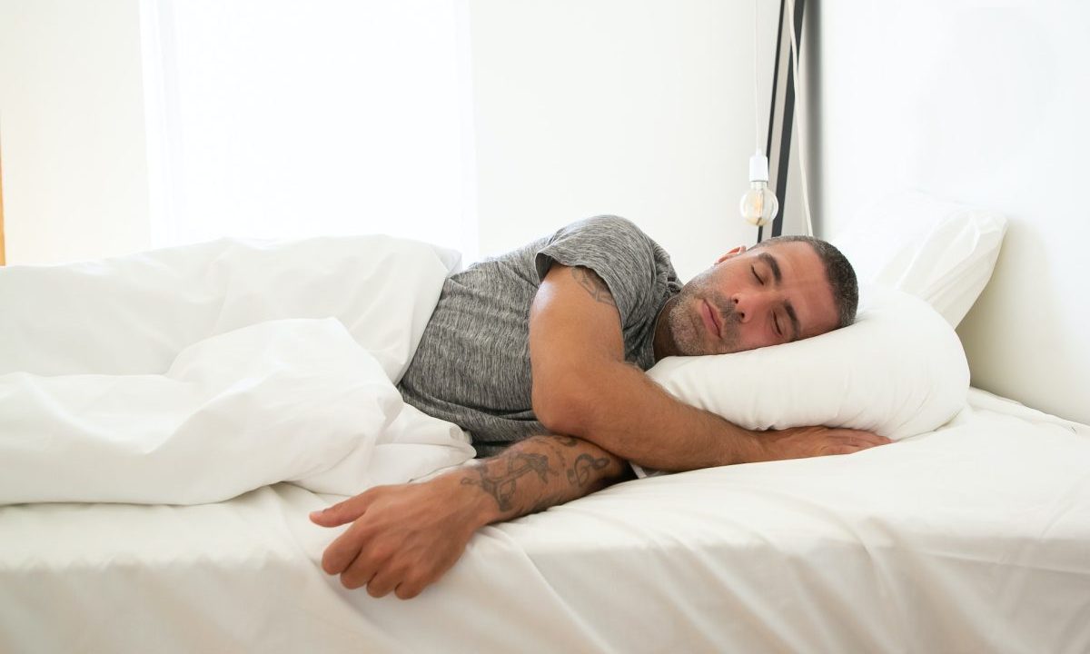A man asleep in bed.