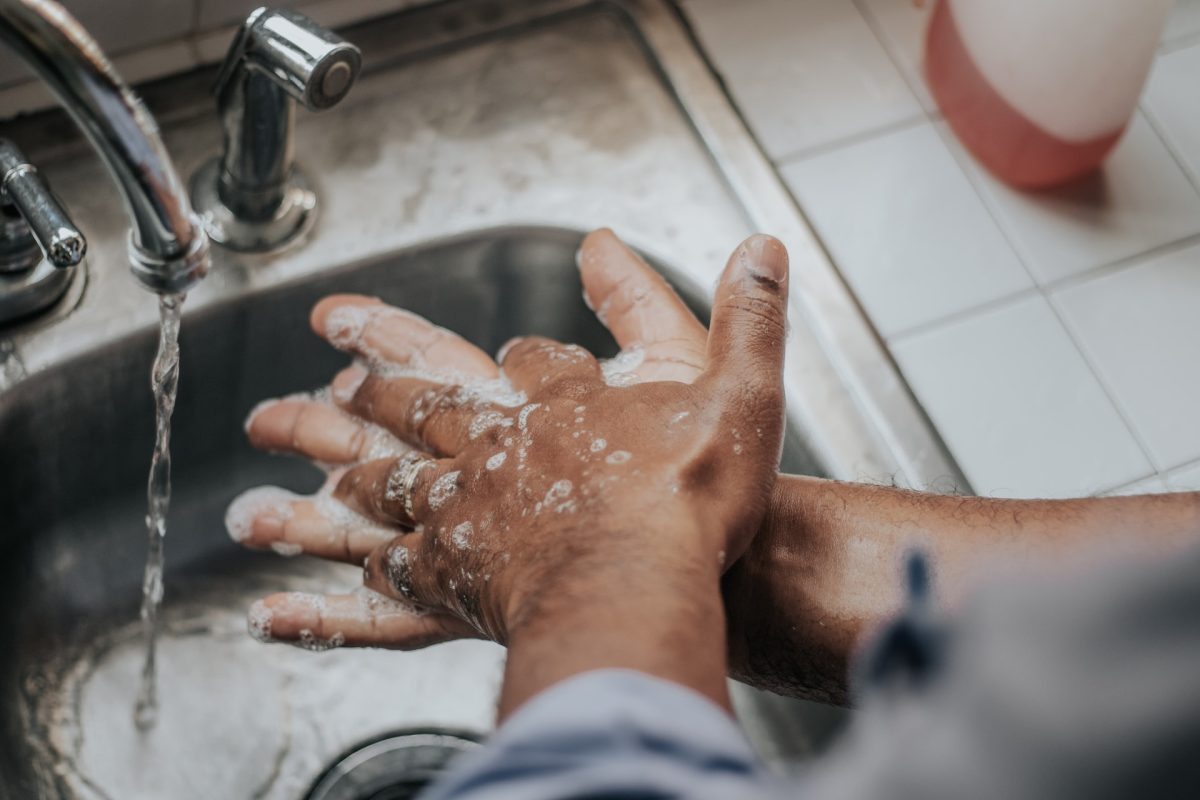 A person washing their hands with soap and water.