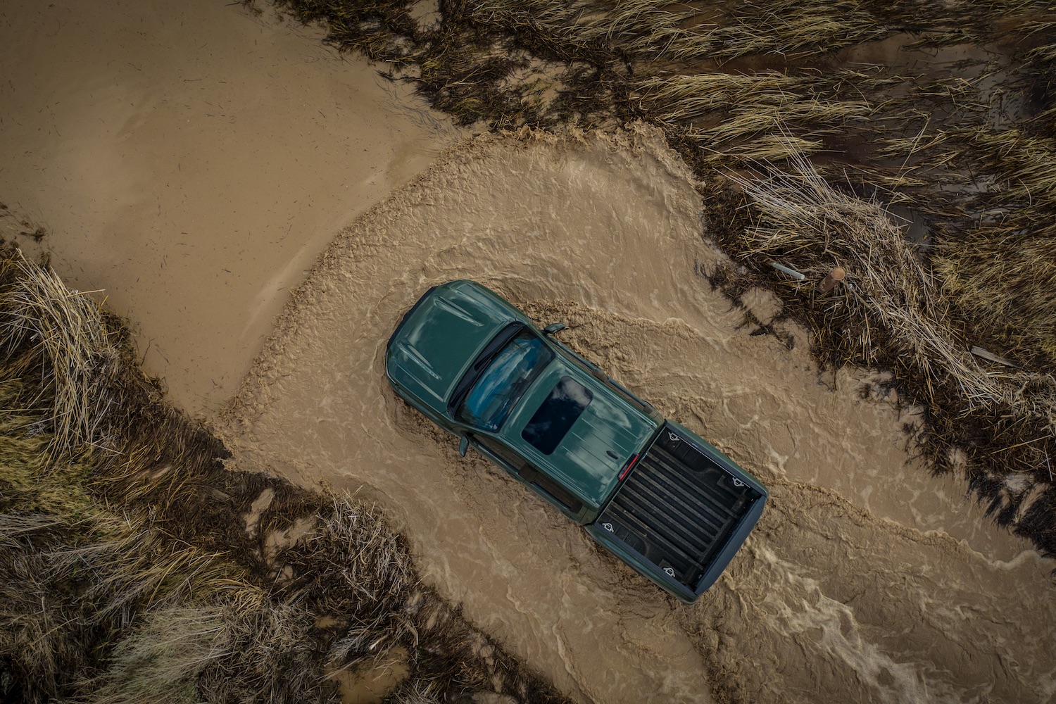 Overhead photo of the 2022 Nissan Frontier Pro-4X fording through deep water in the desert.