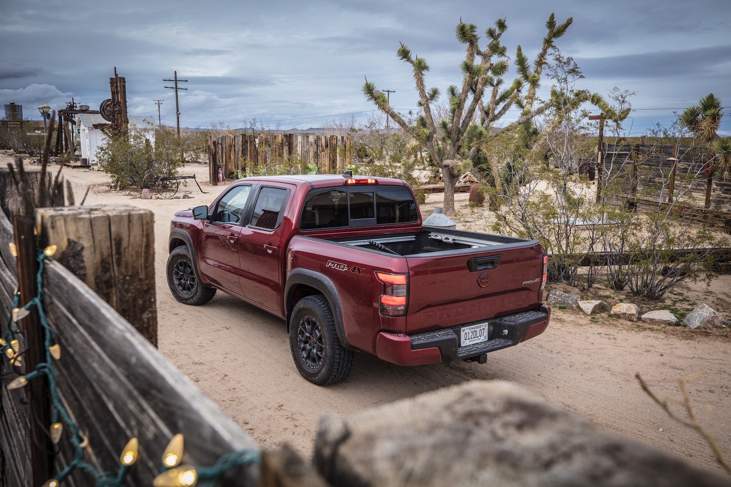 Rear end angle of the 2022 Nissan Frontier Pro-4X parked on a dirt trail.