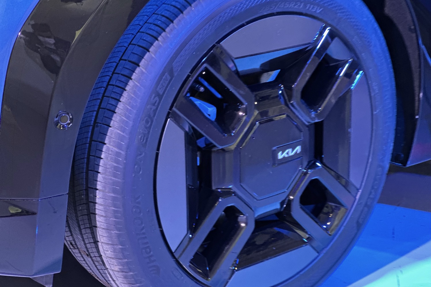 2024 Kia EV9 close up of 21-inch wheels in a studio.