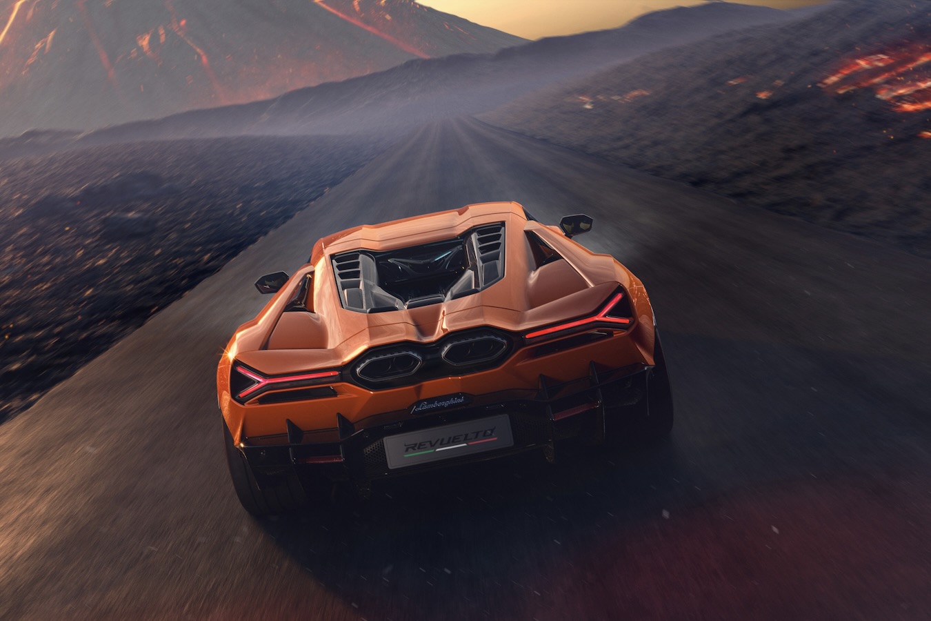 Rear end of the 2024 Lamborghini Revuelto driving down the road with a volcano in the back.