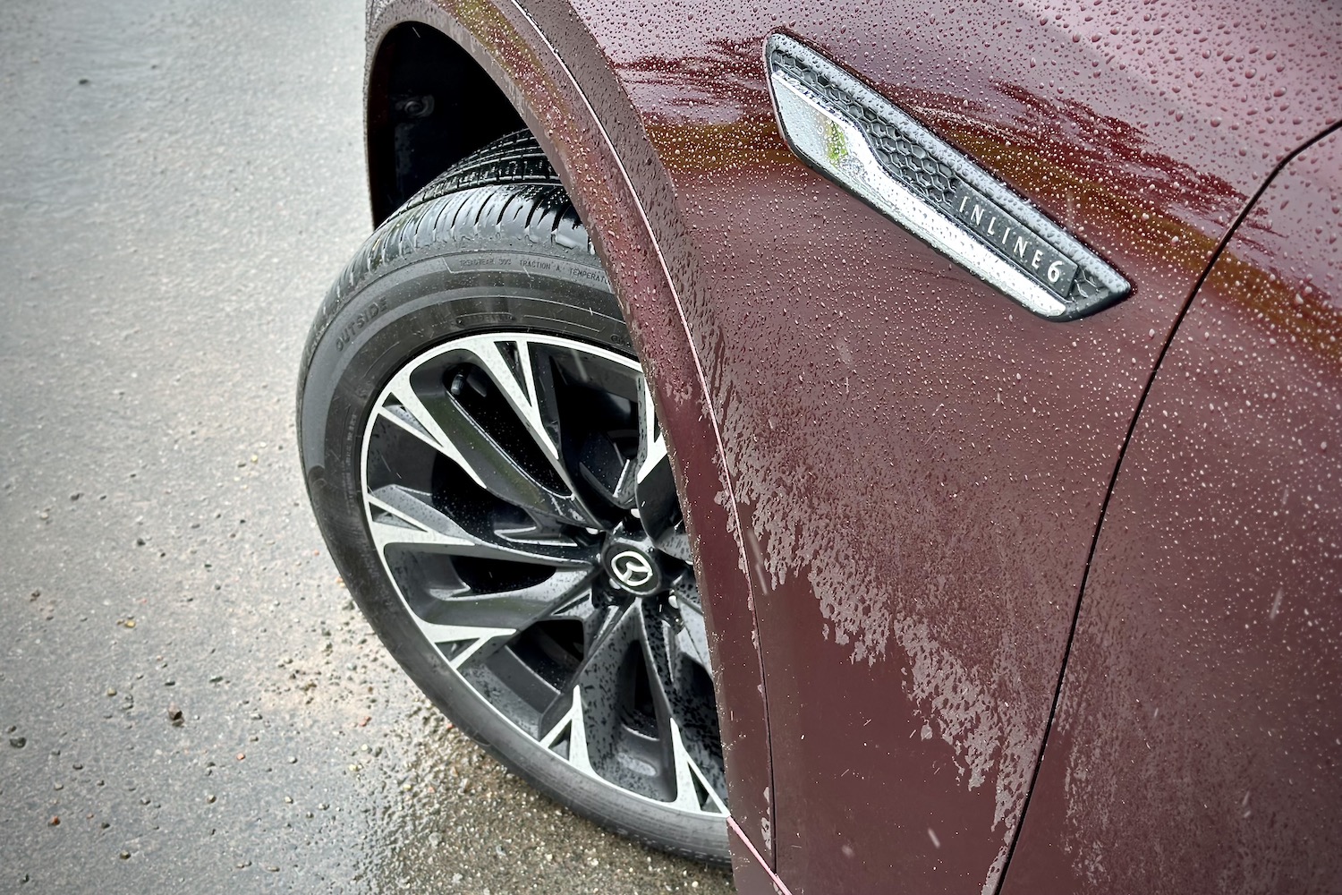 2024 Mazda CX-90 close up of front wheel well with inline six badge.