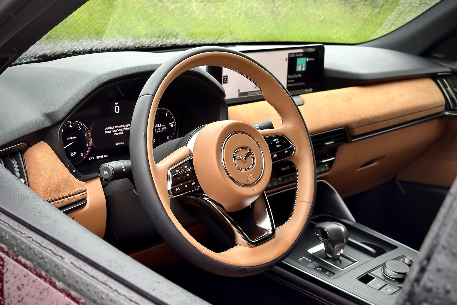 Close up of steering wheel in the 2024 Mazda CX-90 from outside the SUV.